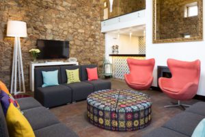 Combining old and new: fancy fabrics and foundations in the lounge in front of the bar of Cerca Design House. © Cerca Design House. All Rights Reserved. by Relógio Global