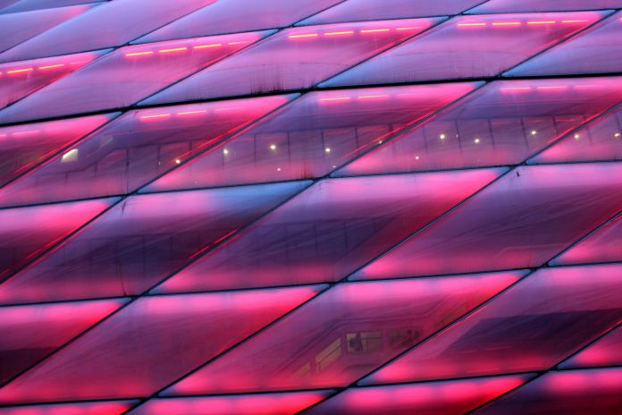 Embellished Close-up of the “Emperors Closet”, stadium of Bayern München, shining in all shades alongside of the motorway.