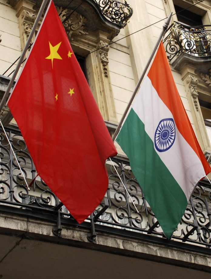 Flags of the Republic of India and the People's Republic of China.